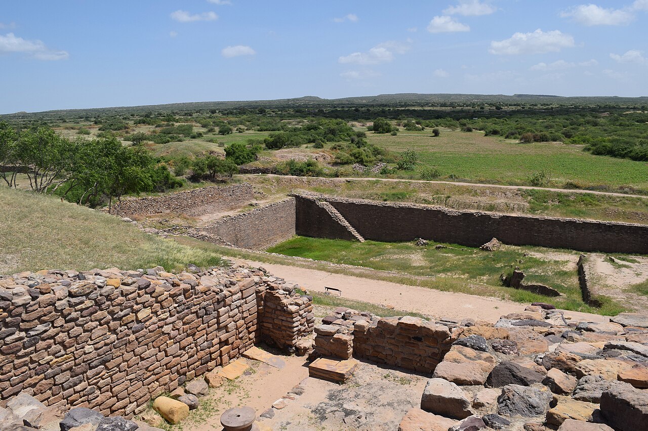 A large stone reservoir with steps leading down, at the ancient city of Dholavira in India.