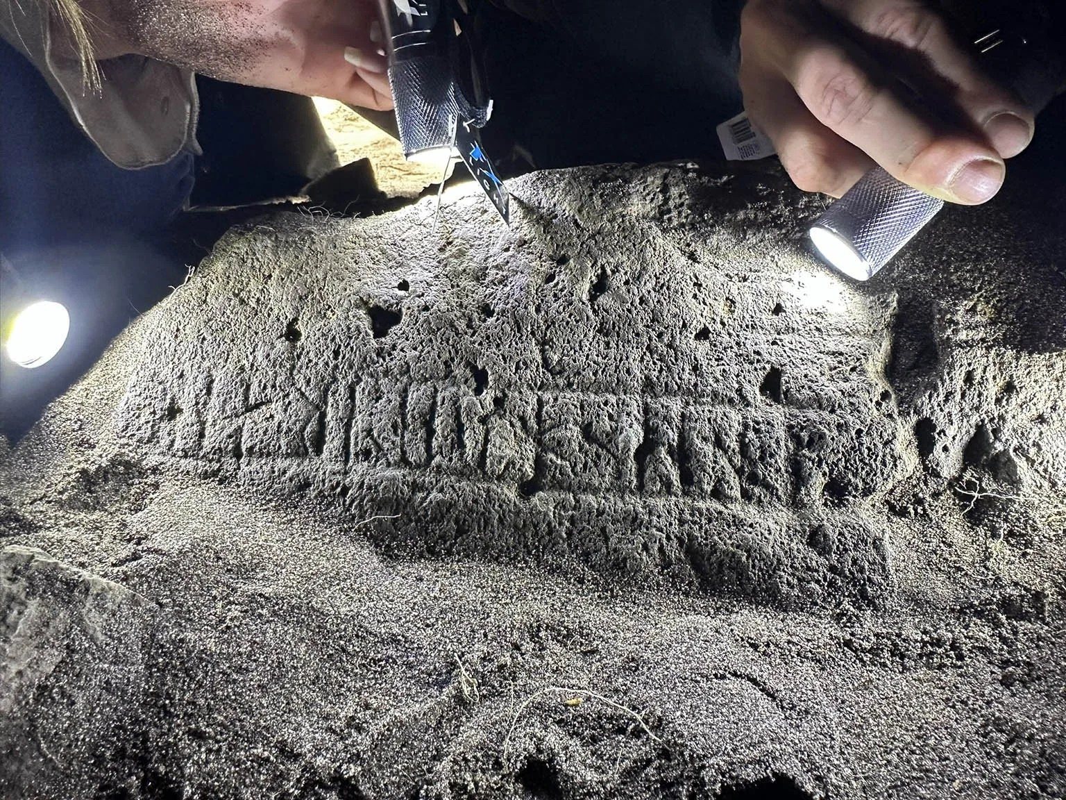 A rune stone set in a small building's floor