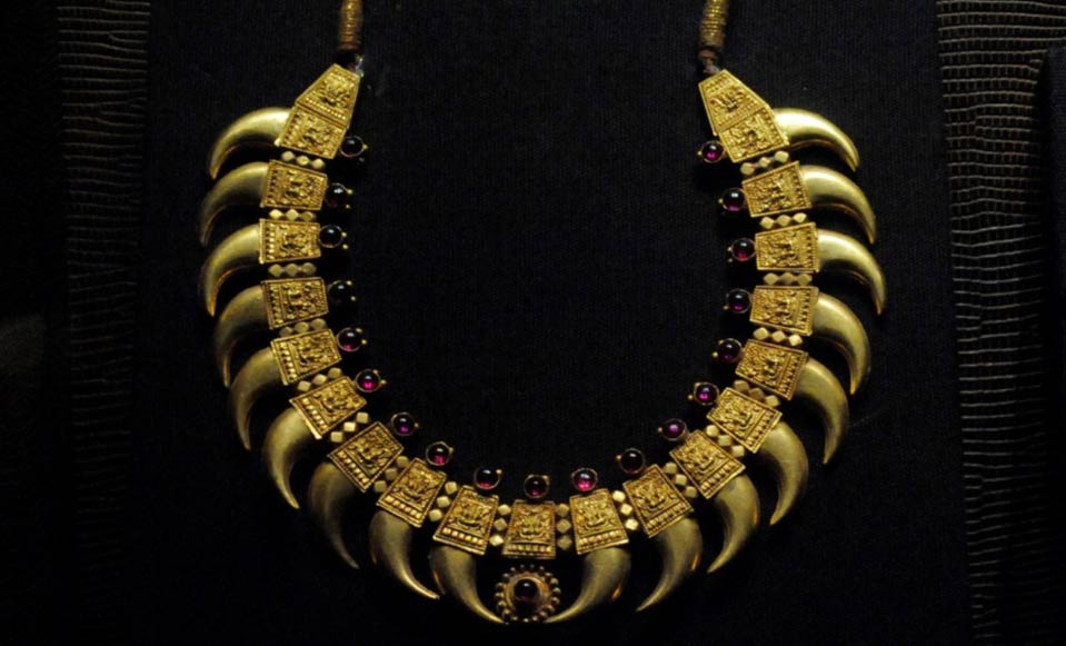 A gold-capped bead necklace.