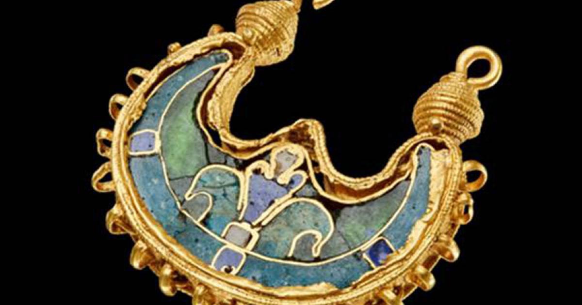 A gold earring dug up in a field.