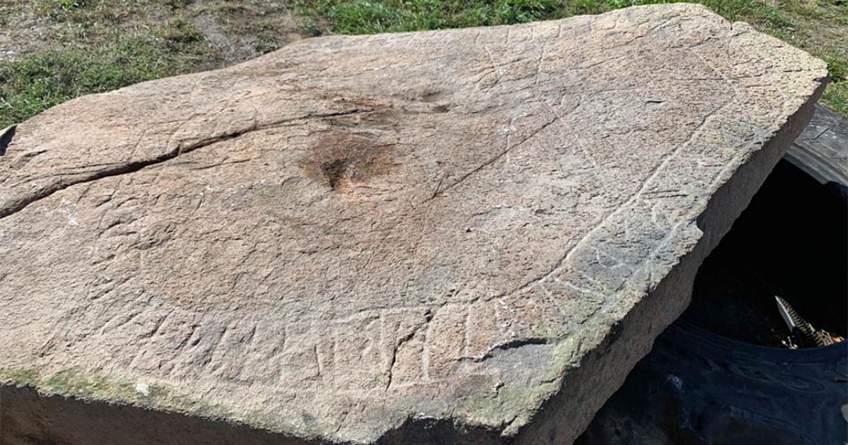 Runes on a stone under a field.