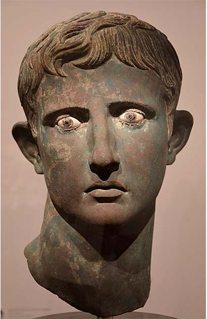 A bronze head buried under temple steps