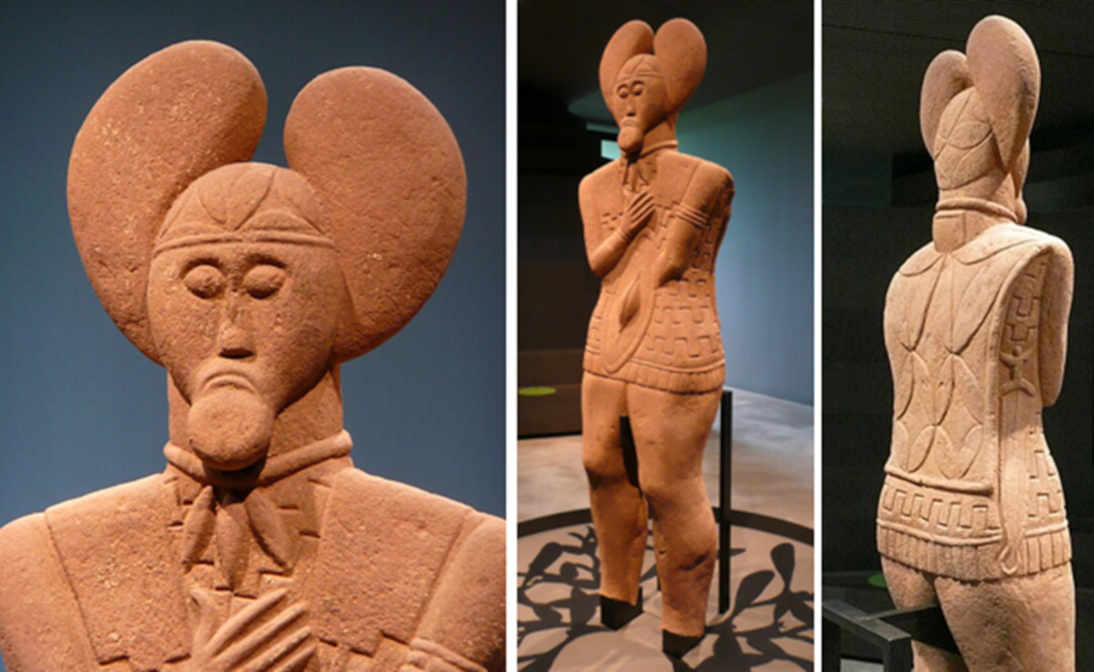 A life-sized stone warrior and a gold neck ring