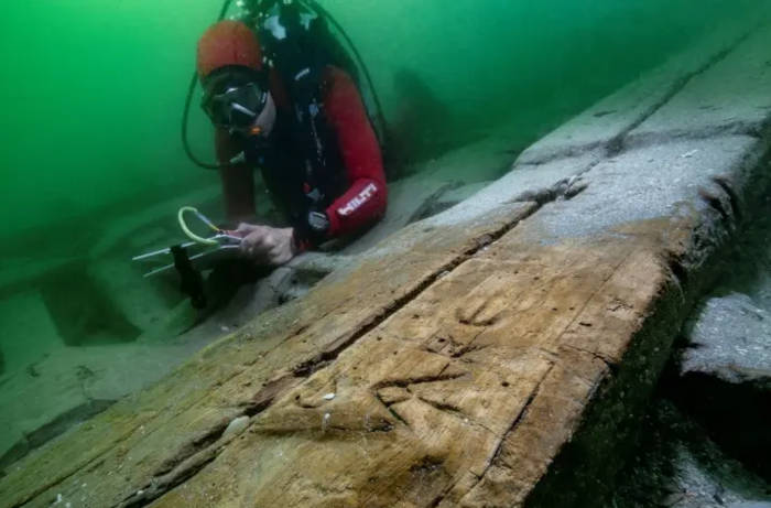 A flat-bow cabin boat by a sunken temple
