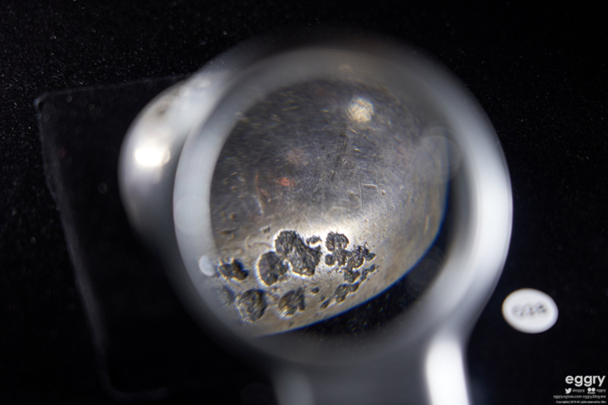 A silver bowl with about 25 signs