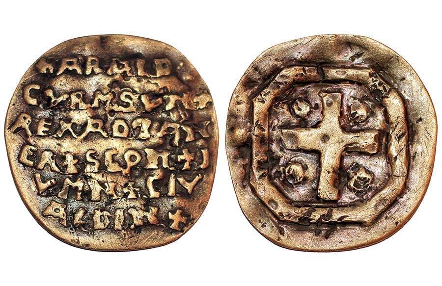 A small gold disc with Latin letters