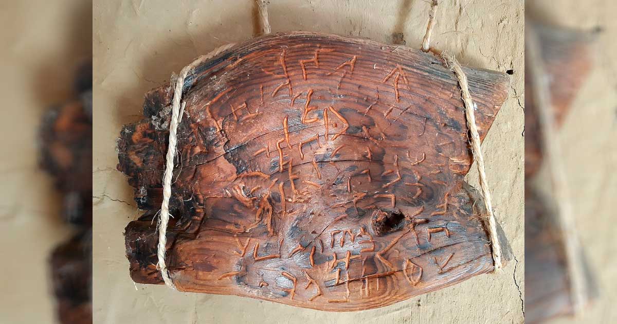 A wooden tablet with carved signs